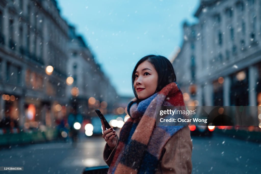 Beautiful Young Woman Using Smartphone On The High Street