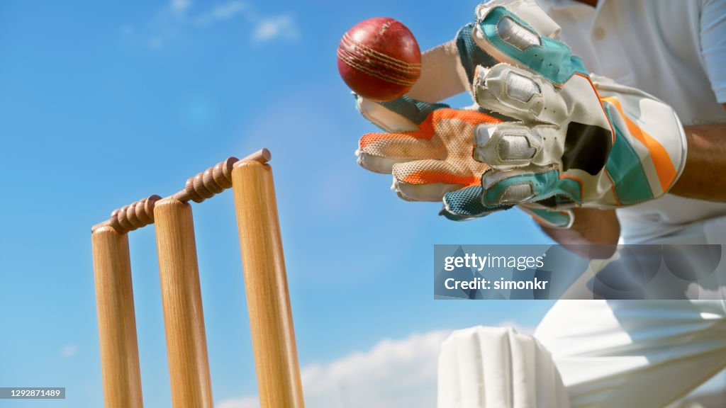 Wicketkeeper catching cricket ball