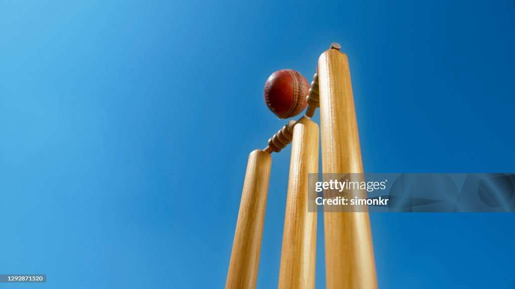 Cricket ball hitting the stumps