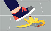 Foot in shoe about to step on banana peel - cartoon person in sneakers