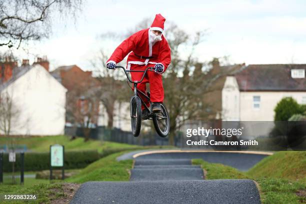 Rider Ollie Whitworth rides the pump track at St George's Park dressed as Santa Claus on December 24, 2020 in Kidderminster, England.