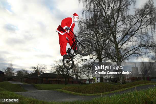 Rider Ollie Whitworth rides the pump track at St Georges Park dressed as Santa Claus on December 24, 2020 in Kidderminster, England.