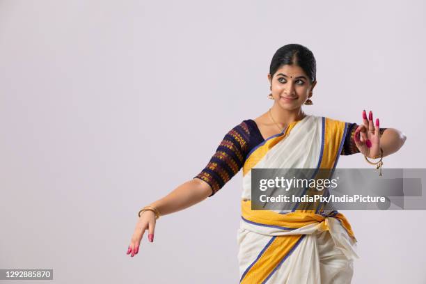 classical dancer doing a mudrakhya mudra - kerala saree stock pictures, royalty-free photos & images