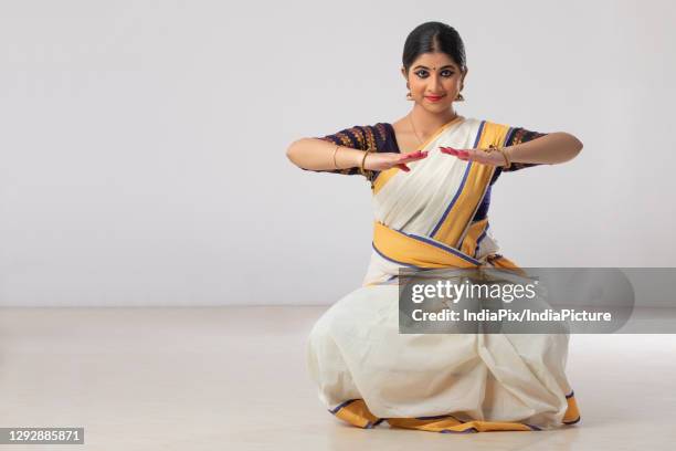 mohiniattam dancer in a tripathaka mudra - kerala saree stock pictures, royalty-free photos & images