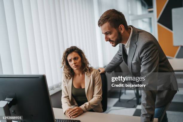 male and female office employees having argument at workplace - bossy stock pictures, royalty-free photos & images