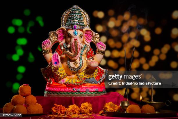 idol of lord ganesha with sweets - ganesha stock pictures, royalty-free photos & images