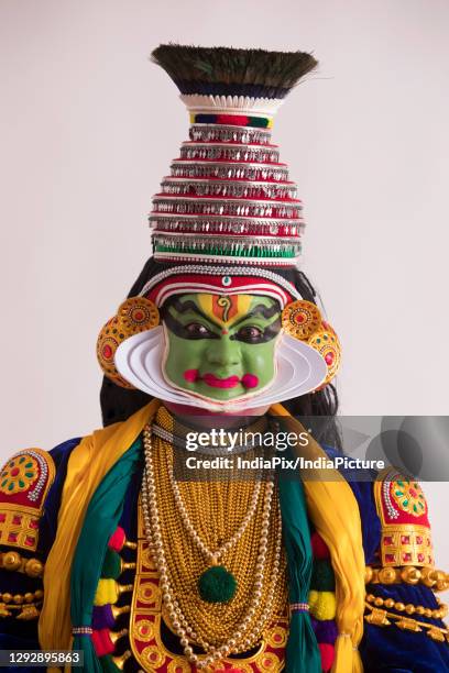 kathakali dancer smiling in his traditional outfit. - kathakali dancing stock pictures, royalty-free photos & images