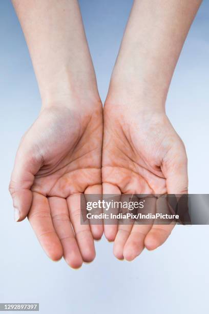 close up of hands on a plain background. - plain background please stock-fotos und bilder