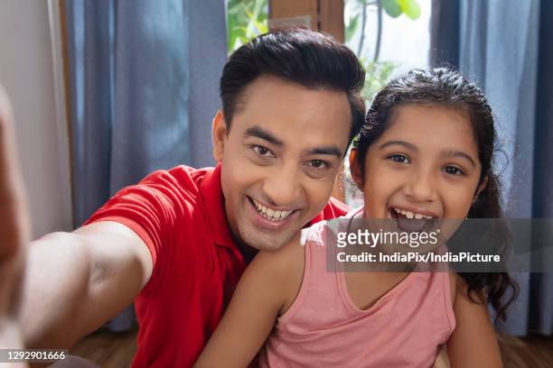 father and daughter enjoying at home taking selfies with smart phone - father clicking selfie bildbanksfoton och bilder