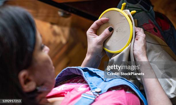 close up of woman doing some needlework - embroidery frame stock pictures, royalty-free photos & images