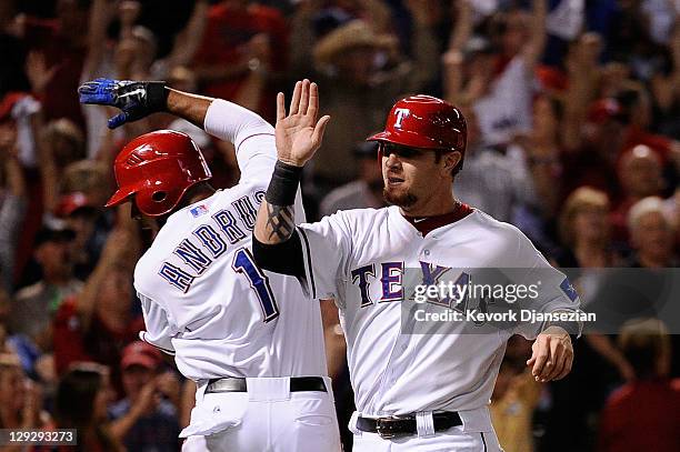 Josh Hamilton and Elvis Andrus of the Texas Rangers celebrate after scoring in the third inning to tie Game Six of the American League Championship...