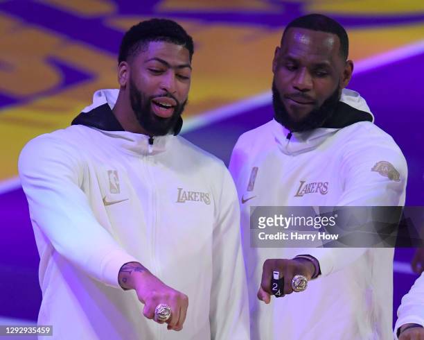 LeBron James and Anthony Davis of the Los Angeles Lakers pose with their rings during the 2020 NBA championship ring ceremony before their opening...