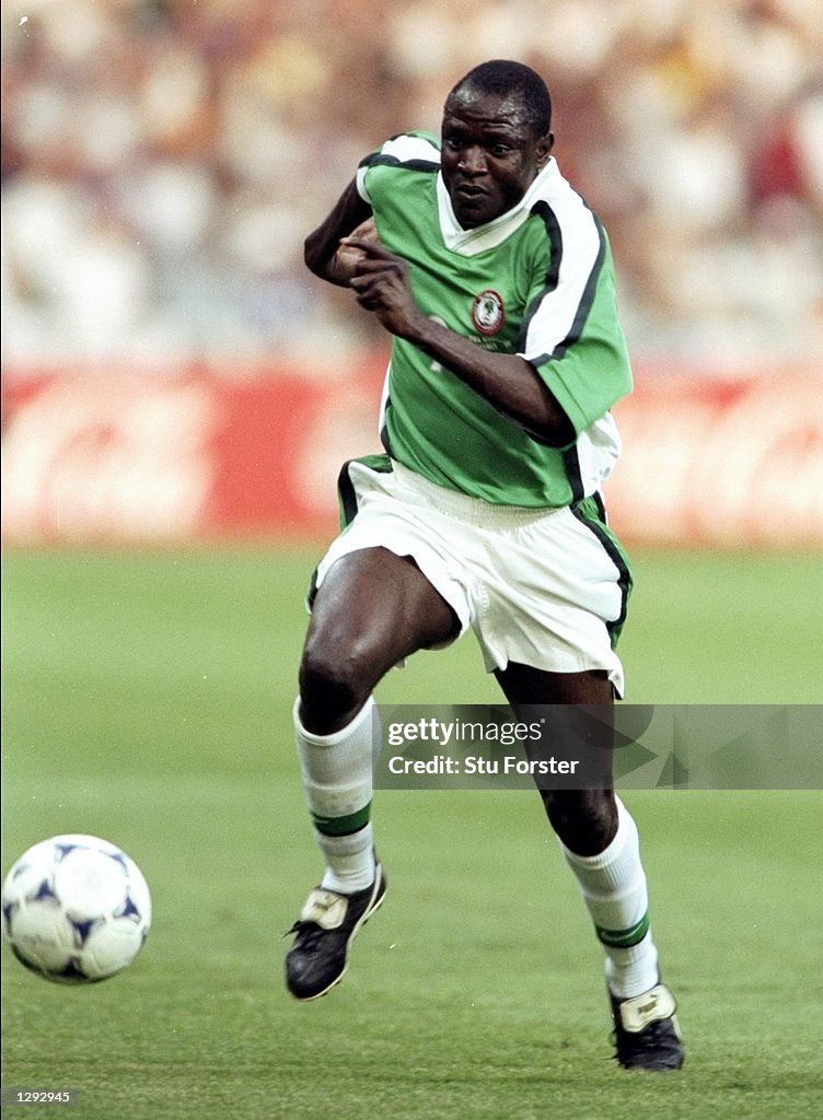 Rasheed Composing Rasheed Yekini of Nigeria charges forward during the World Cup group ...