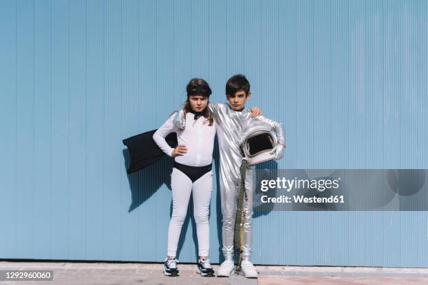 two kids in astronaut and superhero costumes - retro futurism space stock pictures, royalty-free photos & images