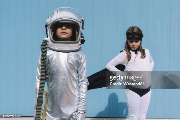 two kids in astronaut and superhero costumes - child standing stock pictures, royalty-free photos & images