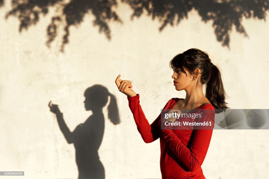 Contemplating Position Contemplating Woman Doing Hand Gesture While Standing By Tree Shadow ...