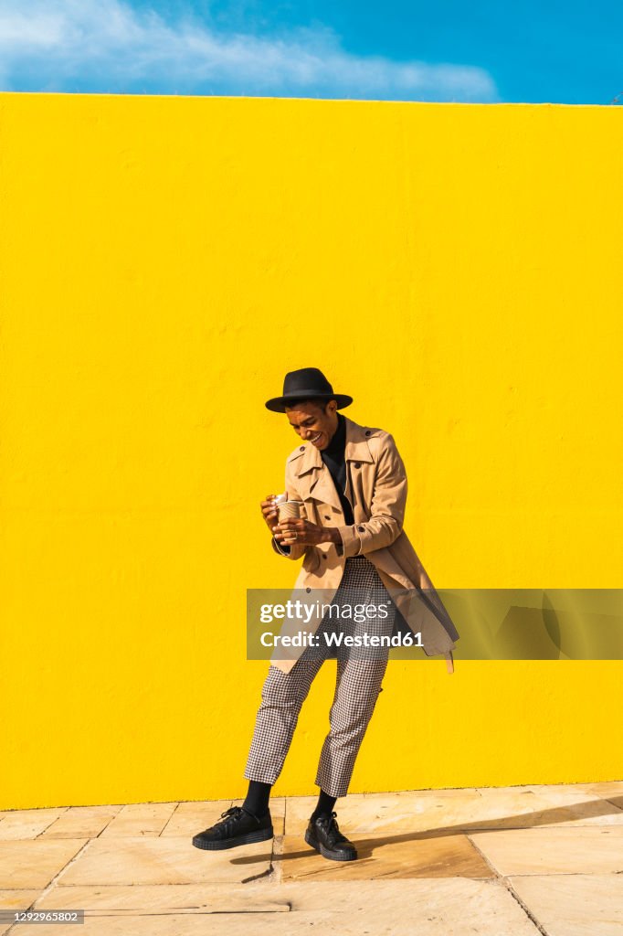 Young man enjoying his take-out coffee