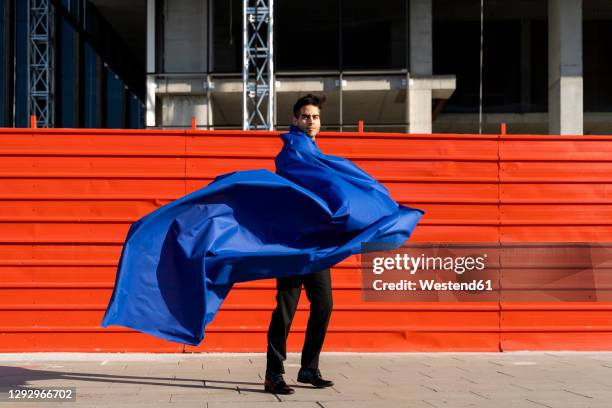 businessman wearing superhero cape in the city - cape garment stock pictures, royalty-free photos & images