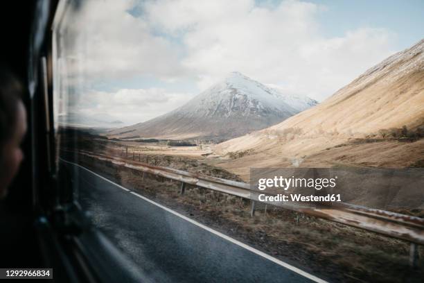 uk, scotland, loch lomond and the trossachs national park, road and mountain seen through car window - scotland snow stock pictures, royalty-free photos & images