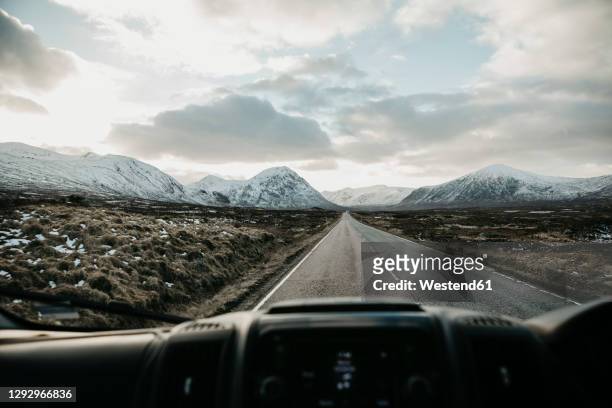 uk, scotland, glencoe, empty road seen through car windscreen - neige épaisse photos et images de collection