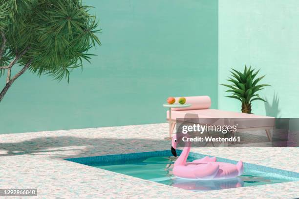 pink toy flamingo floating on swimmingpool next to sunbed and palm trees - palm tree graphic stock pictures, royalty-free photos & images