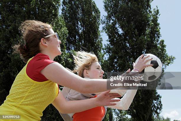 girls playing soccer together - woman catching stock pictures, royalty-free photos & images