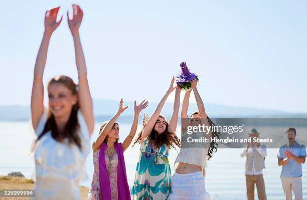 women catching brideãs bouquet - throwing flowers stock pictures, royalty-free photos & images