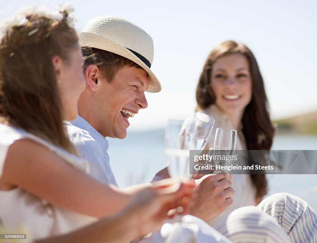 Newlywed couple laughing with friends