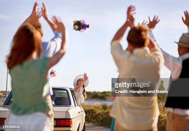 bride throwing bouquet from car - throwing flowers stock pictures, royalty-free photos & images