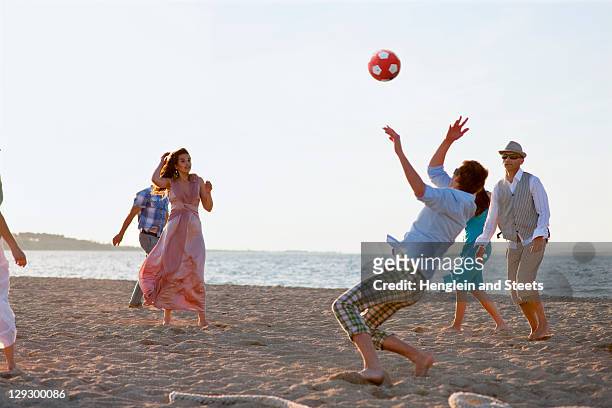 people playing with soccer ball on beach - evening ball bildbanksfoton och bilder