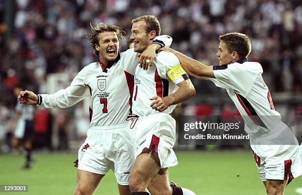 England captain Alan Shearer celebrates with team mates David Beckham and Michael Owen after scoring from the penalty spot during the World Cup...