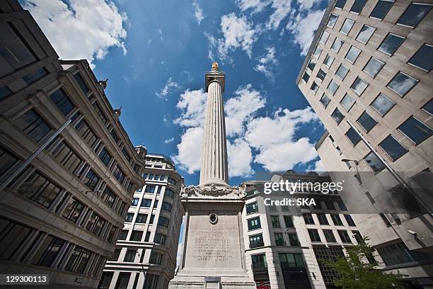 monument on city street against blue sky - great fire of london stock pictures, royalty-free photos & images