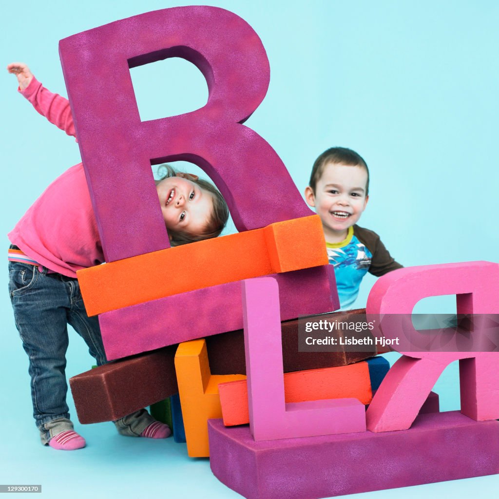 Toddlers playing with oversize letters