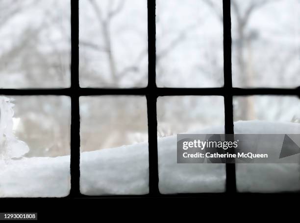 snow accumulation outside leaded glass window of tudor home - storm outside window stock pictures, royalty-free photos & images