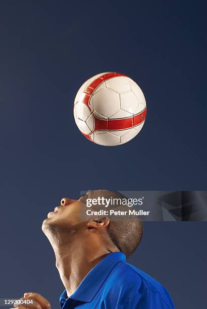 man bouncing soccer ball on his head - heading the ball stock pictures, royalty-free photos & images