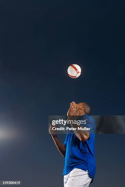 man bouncing soccer ball on his head - heading the ball stock pictures, royalty-free photos & images