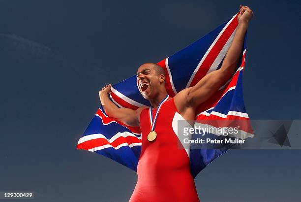 athlete with medal and british flag - sportsperson medal stock pictures, royalty-free photos & images