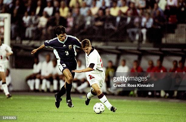 Michael Owen of England shrugs off Jose Chamot of Argentina on his way to goal during the World Cup second round match at the Stade Geoffroy Guichard...