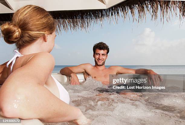 couple sitting in hot tub - hot tub stock pictures, royalty-free photos & images