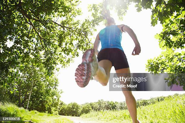 woman running in forest - adrenaline park stock pictures, royalty-free photos & images