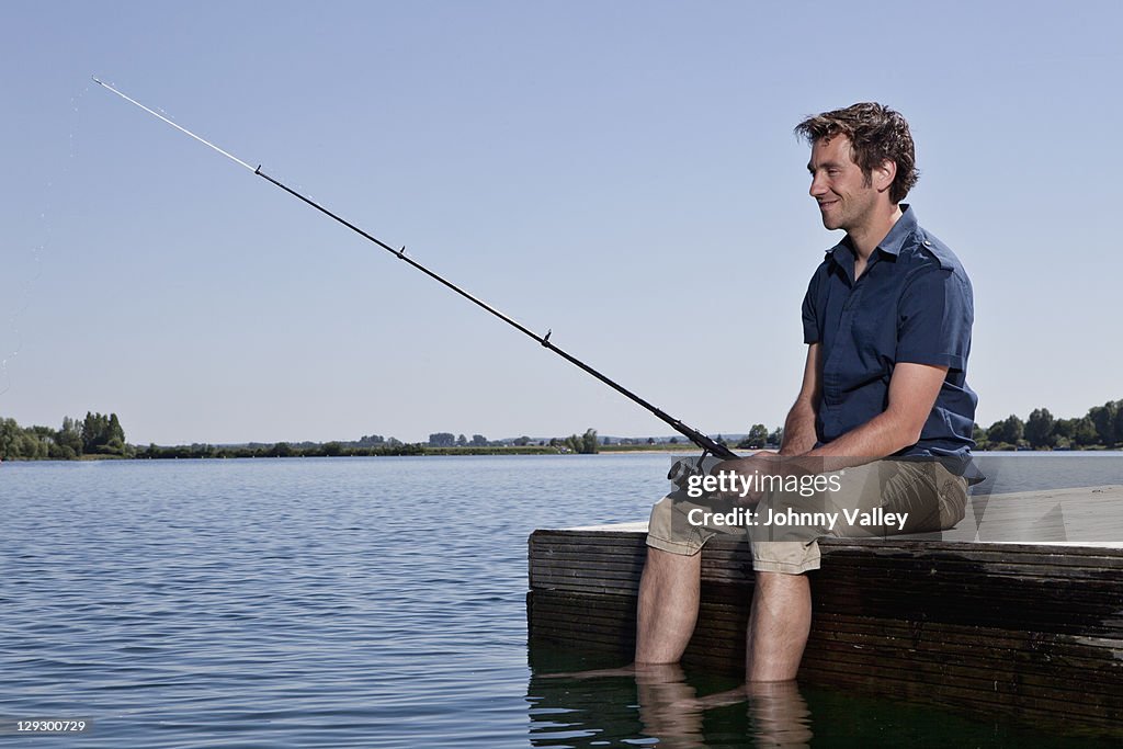 Man fishing on dock