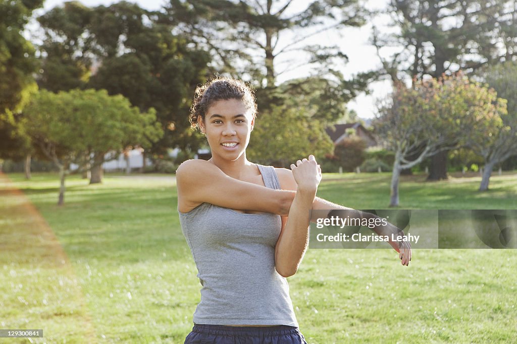 Runner stretching in field