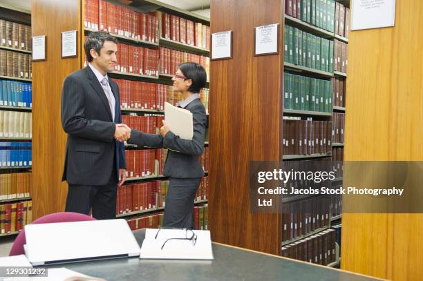 business people doing research in library - law library stock pictures, royalty-free photos & images