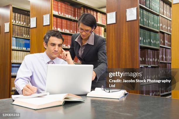 business people doing research in library - law library stock pictures, royalty-free photos & images