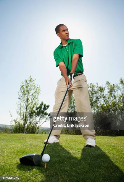 black golfer preparing to swing golf club - full body shot stock pictures, royalty-free photos & images