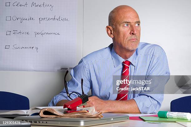 businessman sitting at desk in office - managing uncertainty stock pictures, royalty-free photos & images