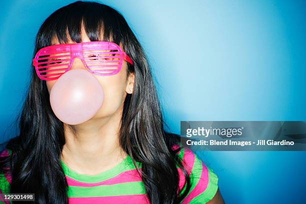 mixed race woman blowing bubble with bubble gum - asian crazy stock pictures, royalty-free photos & images