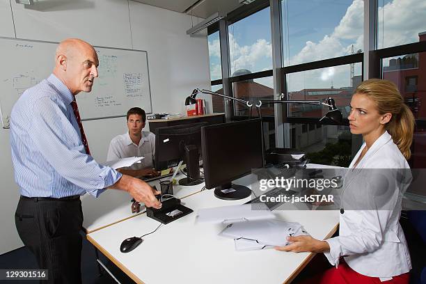 businessman talking to colleagues - assertiveness stock pictures, royalty-free photos & images