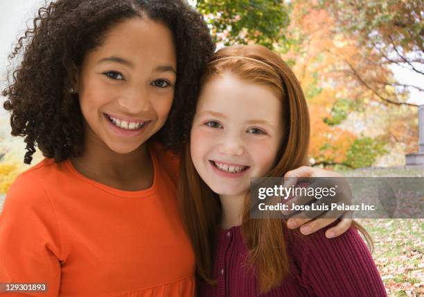 smiling girls hugging outdoors - day 10 imagens e fotografias de stock