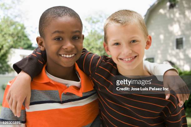 smiling boys hugging outdoors - children only stock pictures, royalty-free photos & images